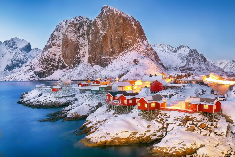Amazing sunset winter view on Hamnoy village and Festhaeltinden mountain on background. Popular tourist destination on Lofotens. Location: Hamnoy, Moskenesoya , Lofoten; Norway, Europe